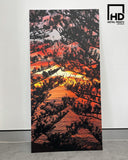 Metal print of tree silhouette leaning against wall